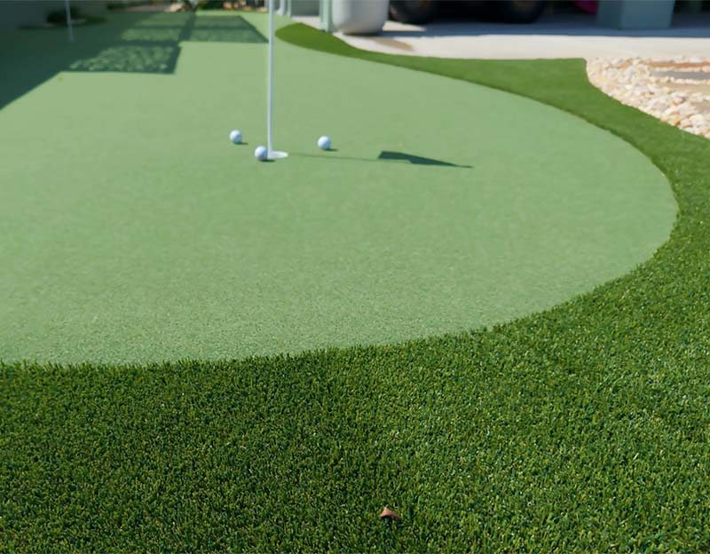 Up close shot of an artificial turf putting green by deep south landscaping