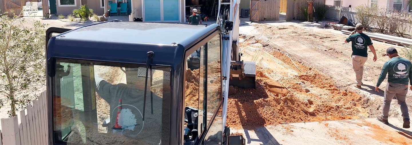 Bobcat working on drainage and leveling for a paver driveway