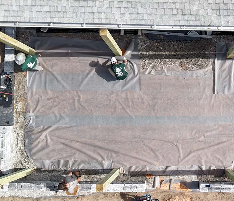 Preparing the ground levels for proper irrigation and drainage on a paver patio