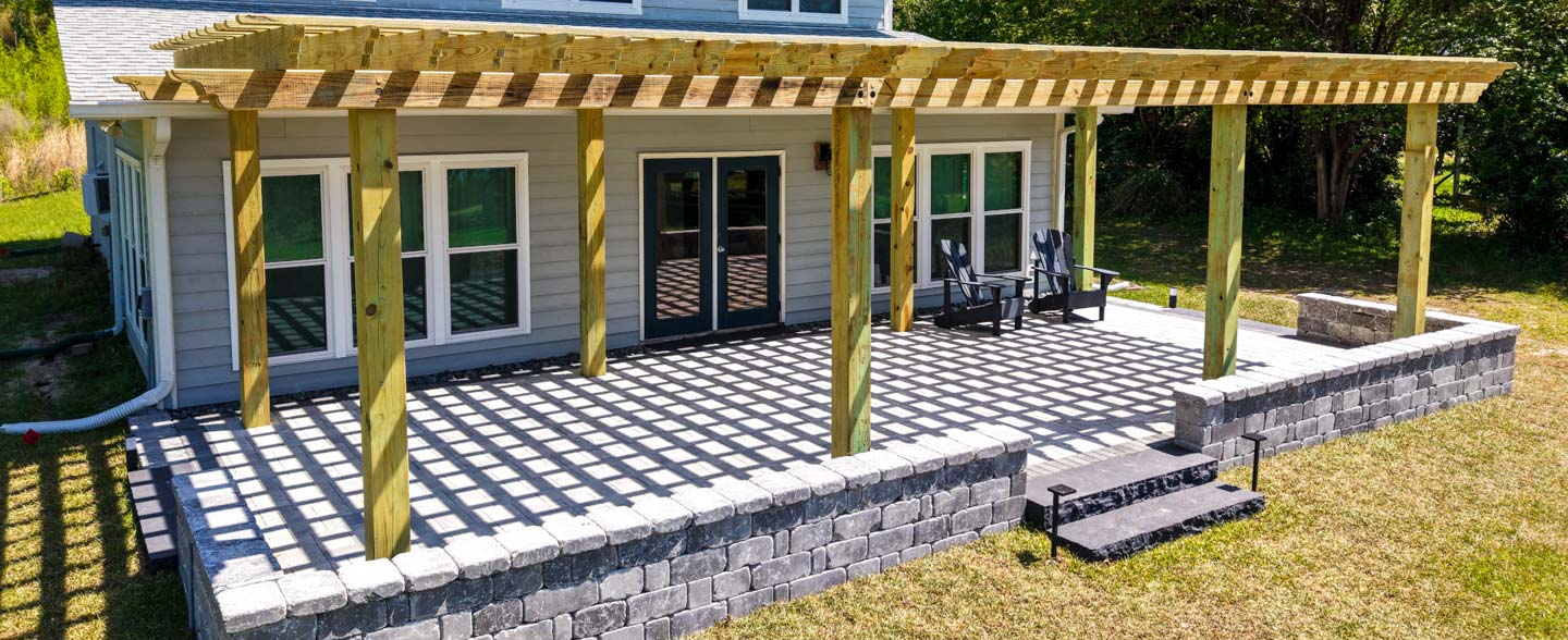 Deep South showing a Hardscaping project complete with custom patio pavers and pergola with planned drainage and sprinkler system