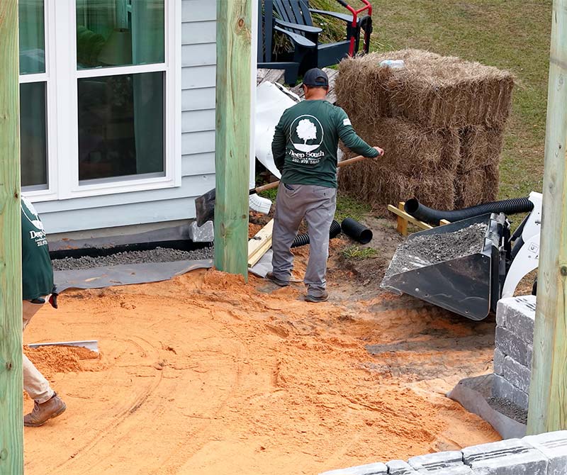 Deep South crew working on ground leveling for proper drainage