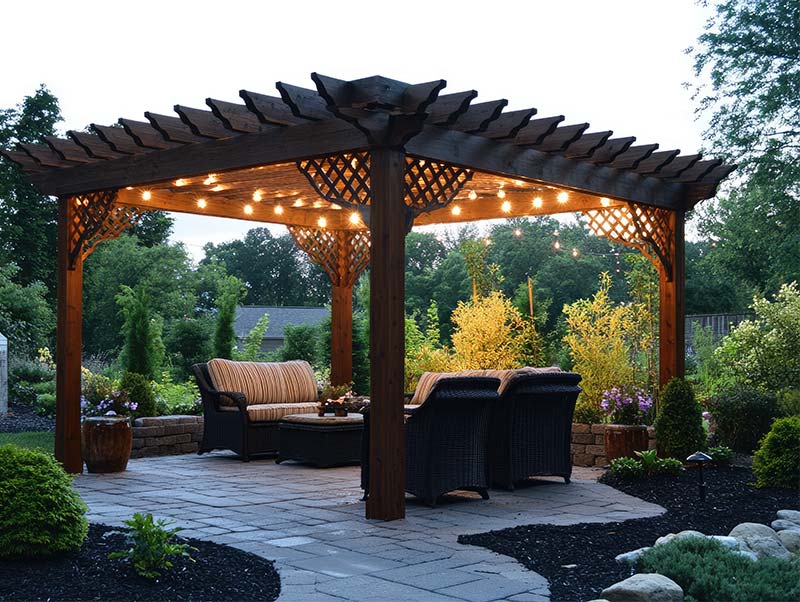 String lights illuminating a relaxing outdoor patio area under a wooden pergola